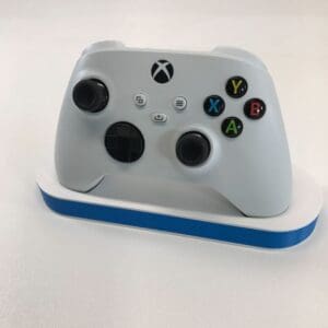 Front view of Xbox controller on minimalist 3D printed stand with modern color design